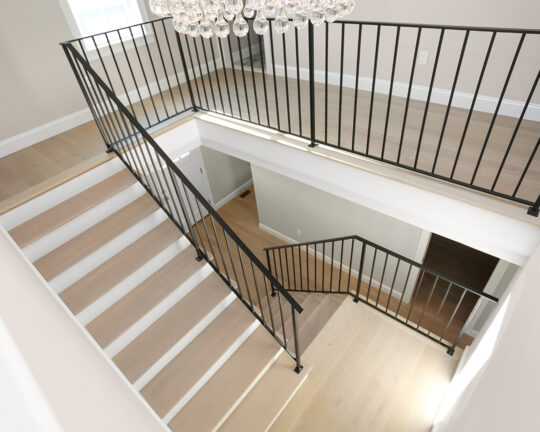 Staircase with matching flooring and stair treads.