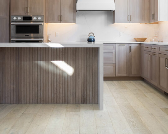 dark wood cabinets light wood floors marble backsplash marble countertops kitchen island