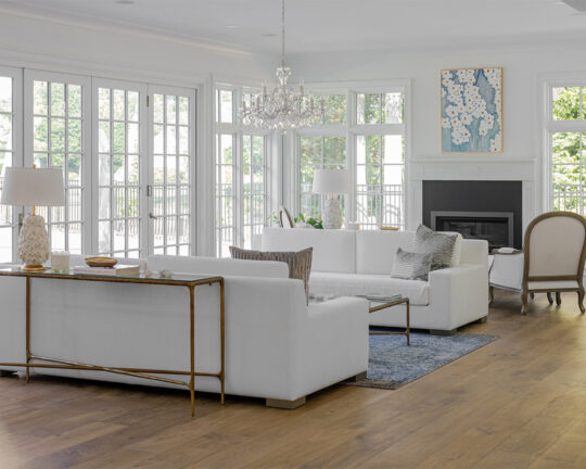 Classy living room with white furniture, tasteful decor, and a wide plank matte finish floor
