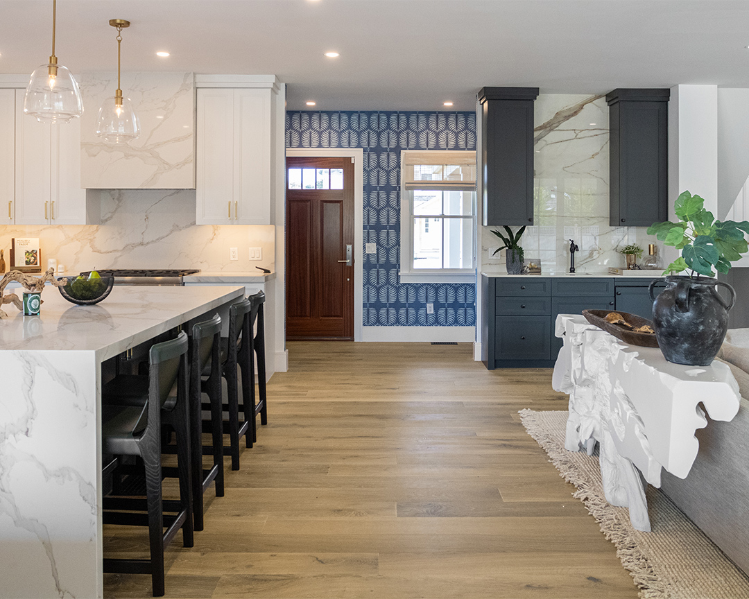Colorful entryway, living room and kitchen island with brown oak wood floor