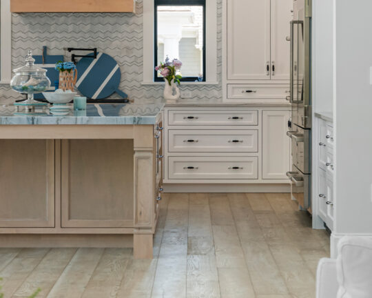 Elegant kitchen with colorful decor and a matte wood floor