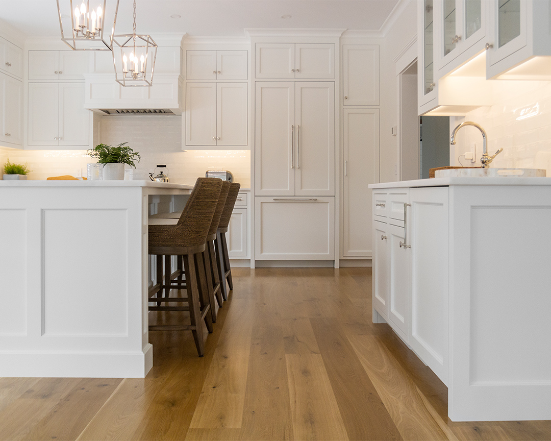 white warm kitchen with dark natural wide plank flooring