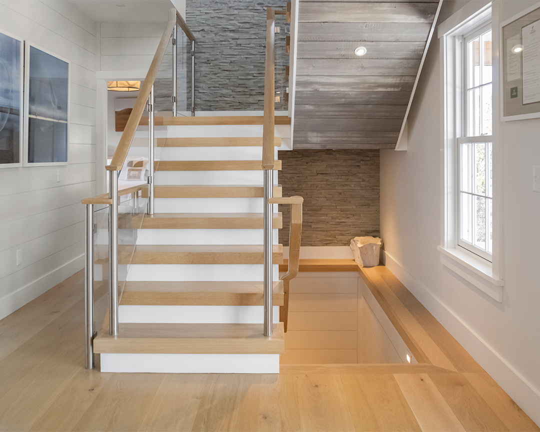 Color coordinated stair treads on modern staircase and matching wood floor.
