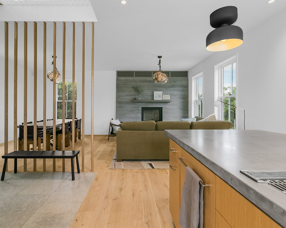 Unique kitchen, living room and dining room design with a wide plank wood floor.