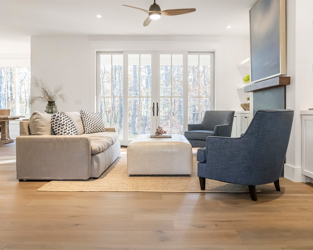 Wide plank oak flooring in a clean living room.