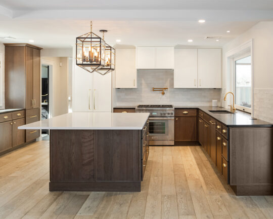 Bright and open modern kitchen design with wood colored island and cabinets with an oak wood floor