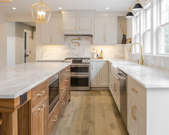 Kitchen design with oak flooring and brown and white cabinets