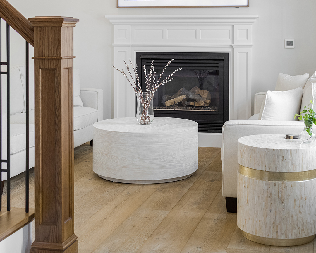 clean modern white living room with fireplace and natural looking wide plank wood floors