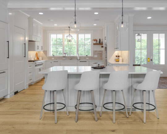 Bright and open kitchen space with white furniture and cabinets accompanied by a smoked and hand colored wood floor