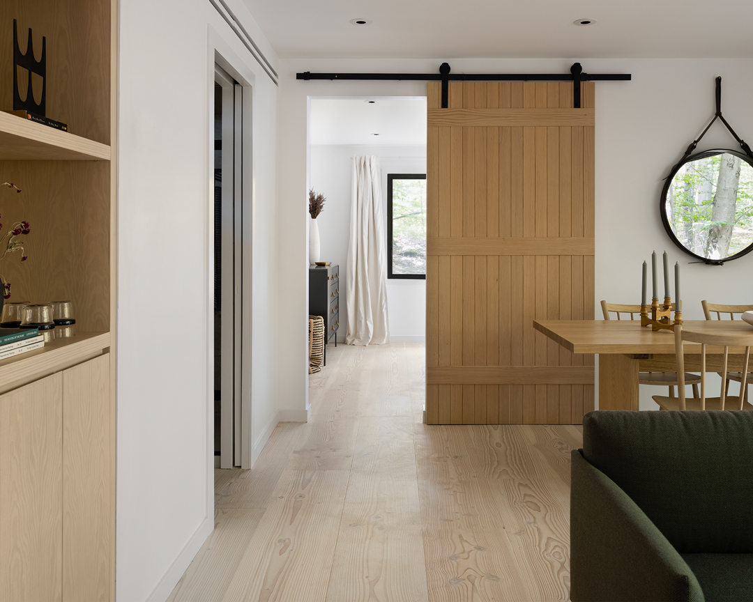 Modern room with light colored wide plank flooring.