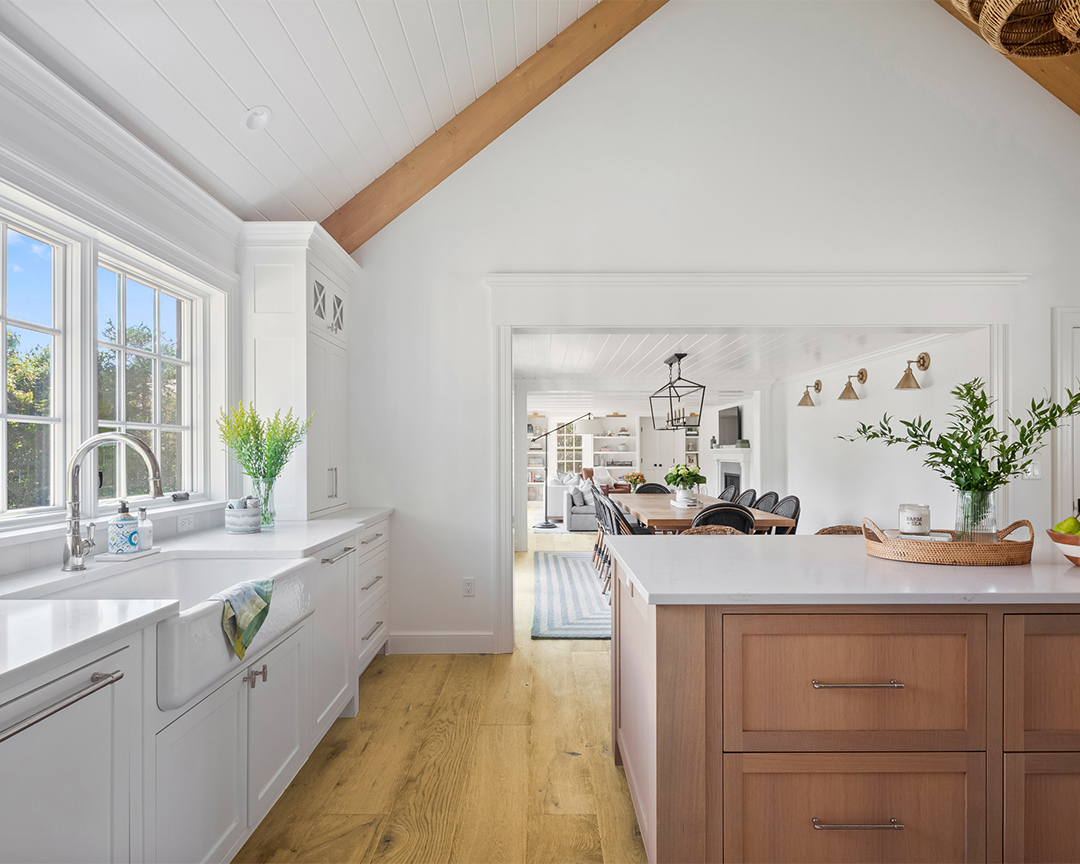 Modern coastal kitchen with brown accents and wide plank wood floor