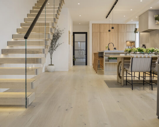 floating staircase kitchen and living room wide plank wood floors and black door