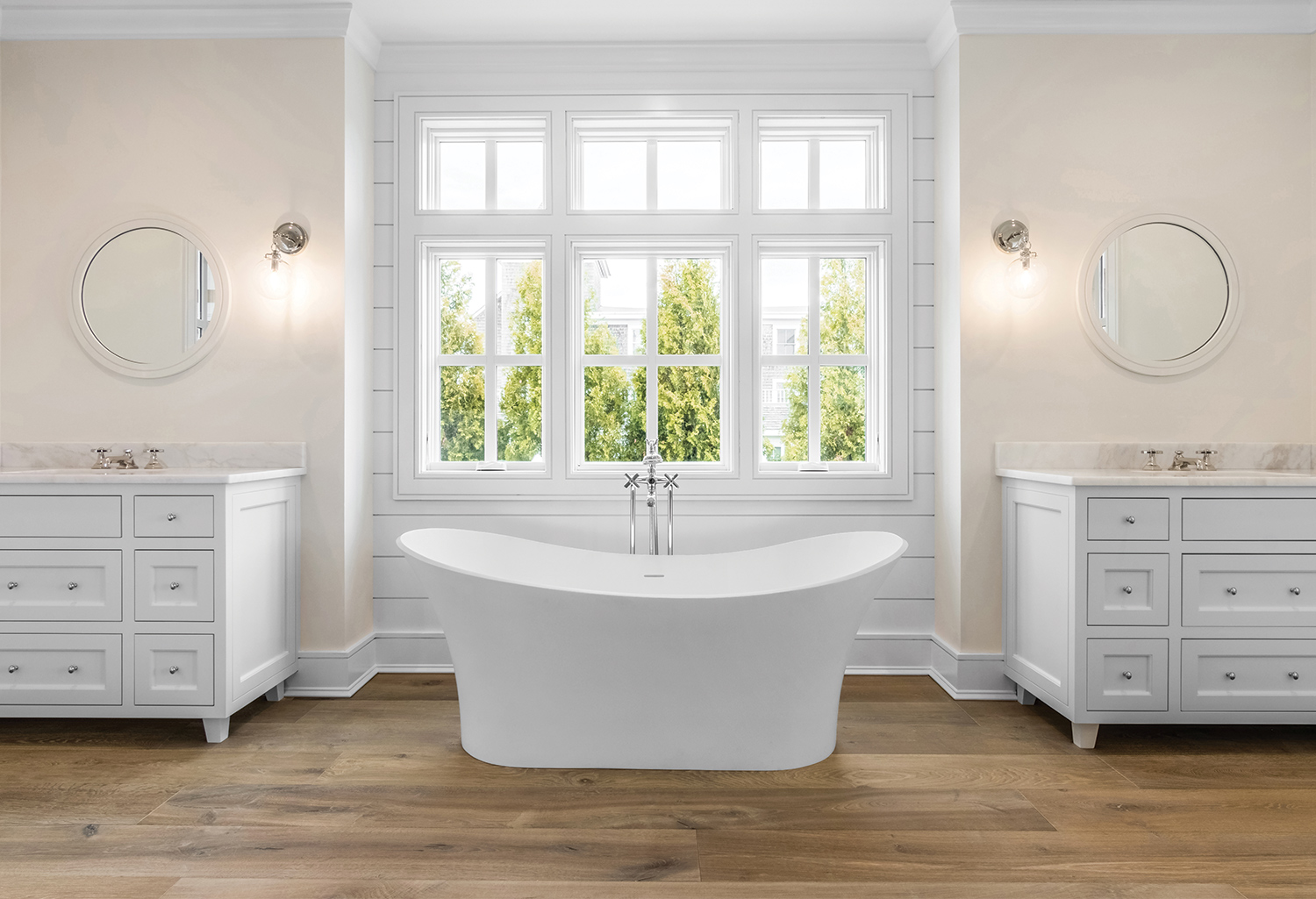 Elegant bathroom with unique bathtub accompanied by wood flooring.