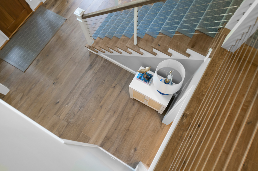 Top down shot of carpeted staircase with color-coordinated stair treads and matching floor.