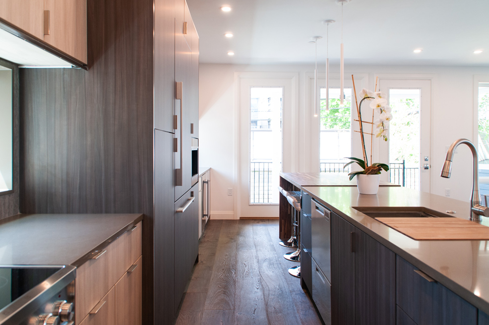 Kitchen interior design with wood paneling, and a wood floor with hand-distressed texture.