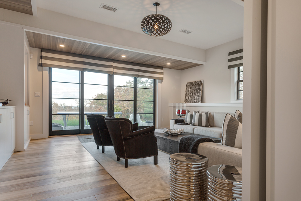 Neutrally colored living room with complementary wood flooring.