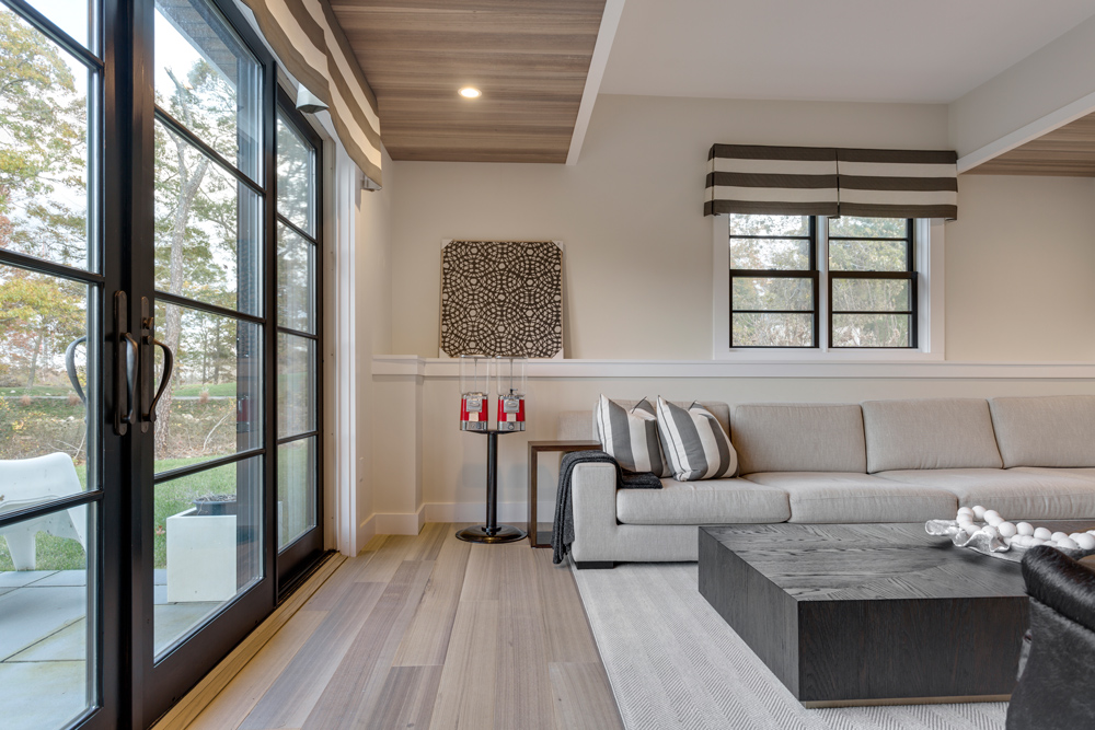 Gray and black colored living room with wide plank wood flooring.