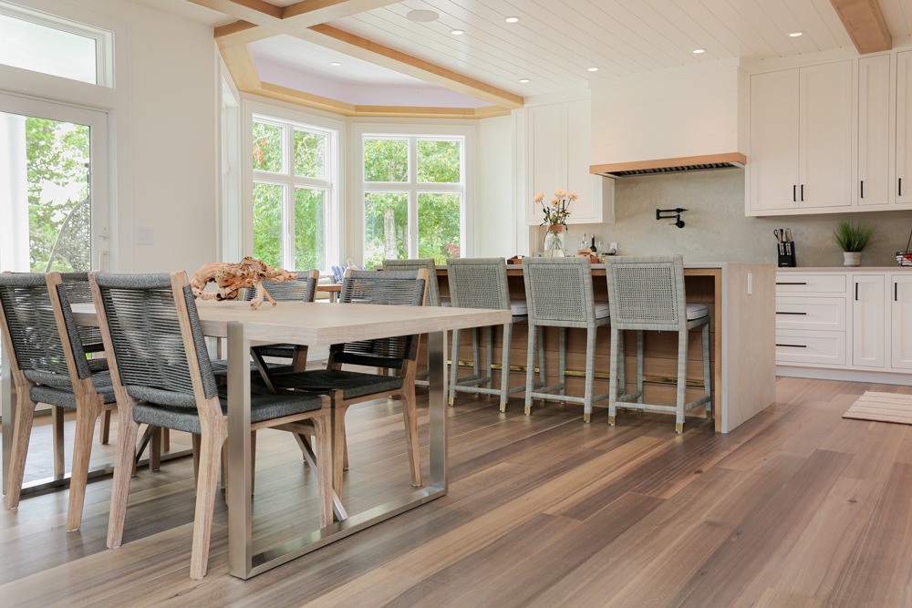 Kitchen and dining area with modern aesthetic and hardwood flooring.