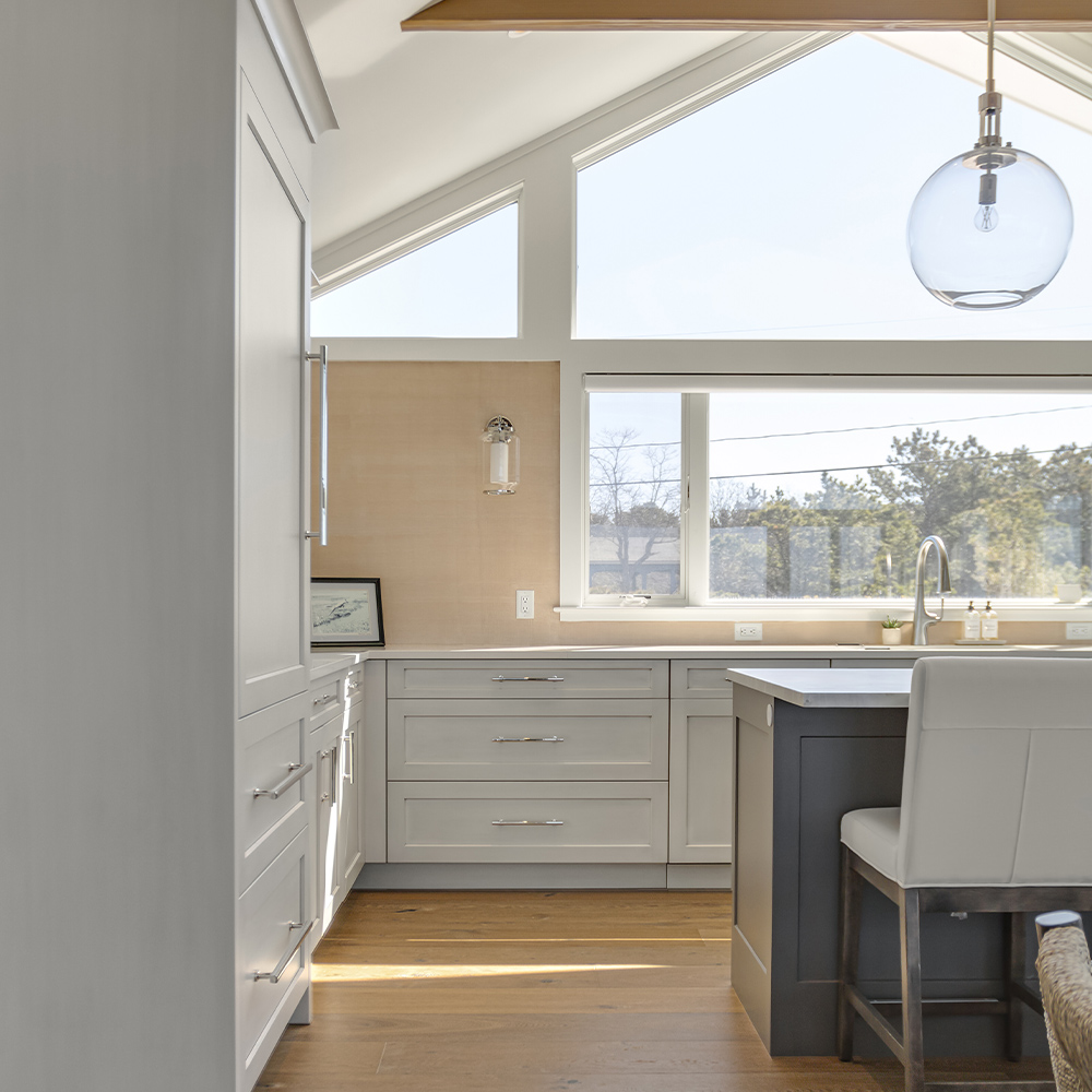 Cozy kitchen with round pendant light and medium brown wood floor.