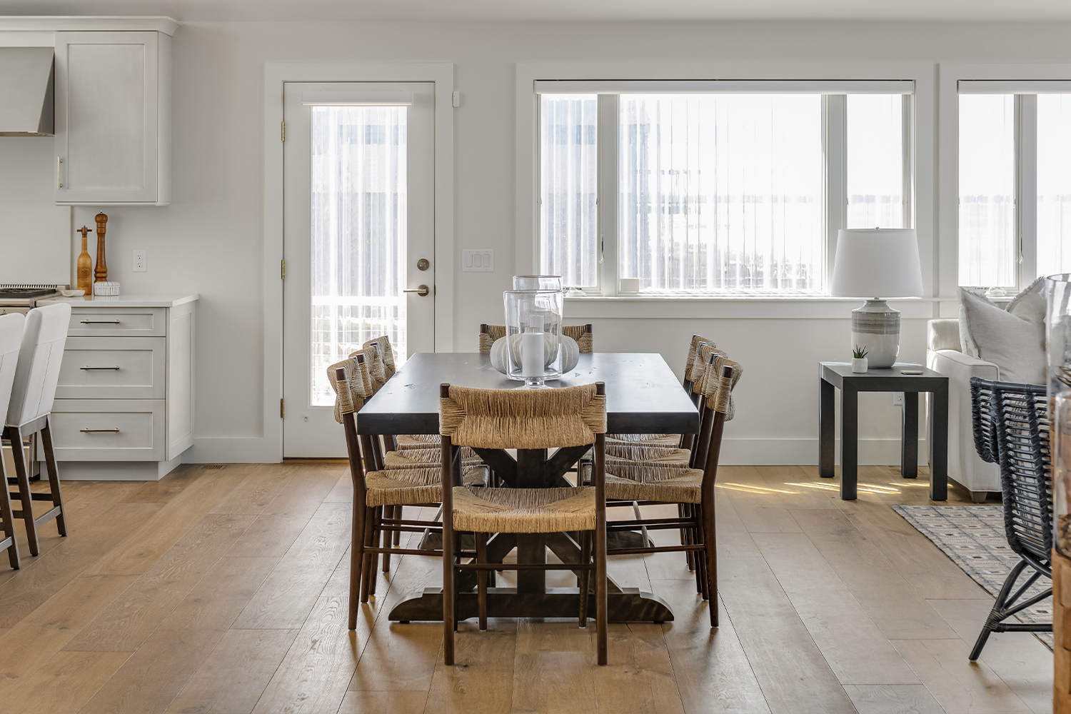 Wide shot of dining area with wide plank wood flooring.