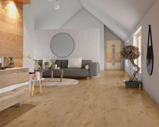Thoroughly decorated living room with light colored wood floor and decorative plants.