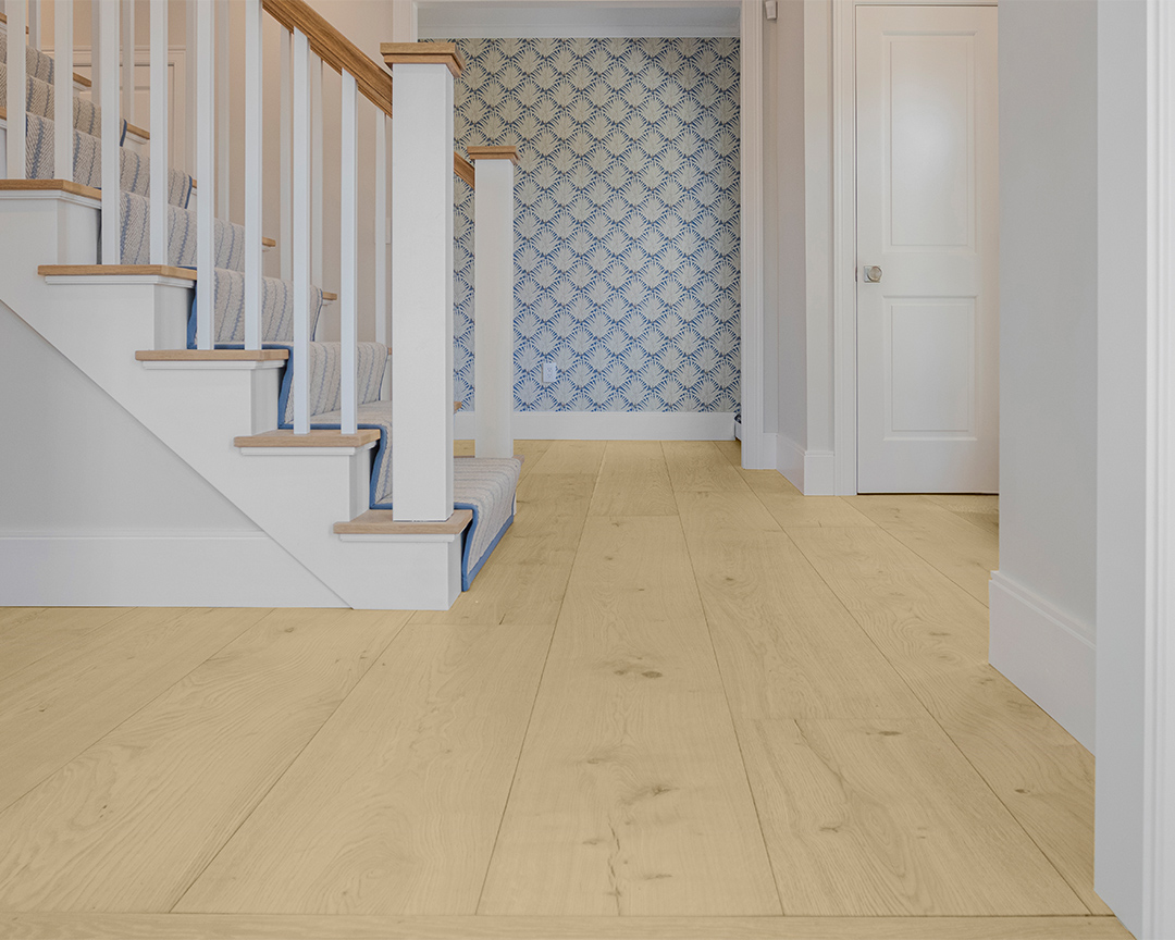 hallway with fun blue and white wallpaper and natural light wide plank floors
