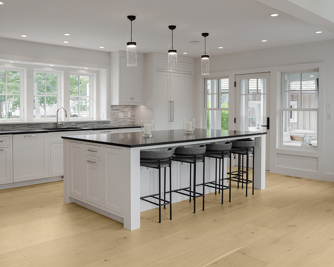 white kitchen black countertops black furniture light fixtures wood floors