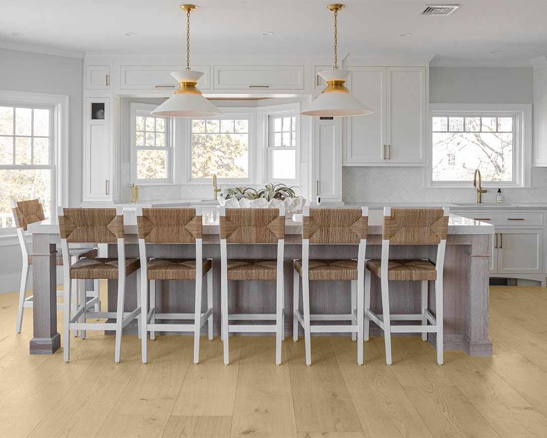 island seating in a bright neutral kitchen with white cabinets, walls, and light wide plank flooring