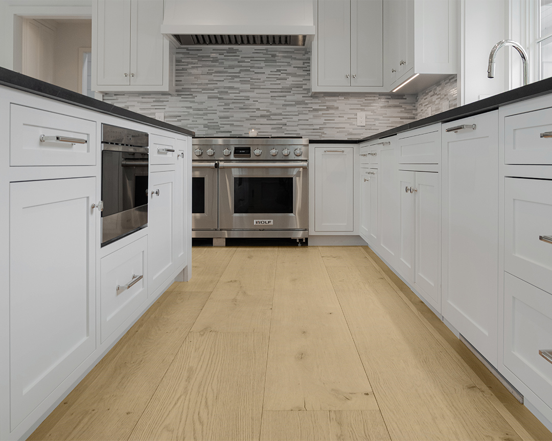 kitchen white cabinets gray backsplash oven oak wood floors