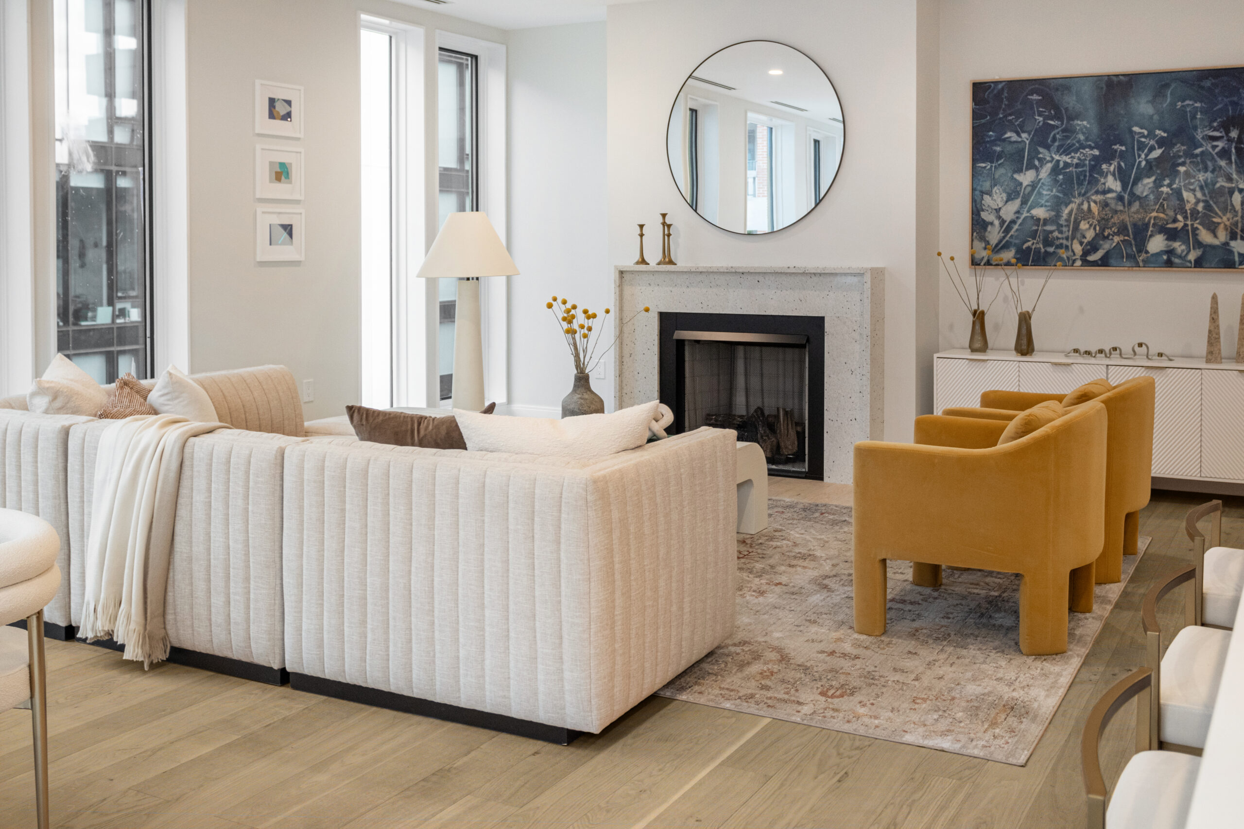 living room with fireplace and neutral toned walls and furniture and light warm wide plank floors