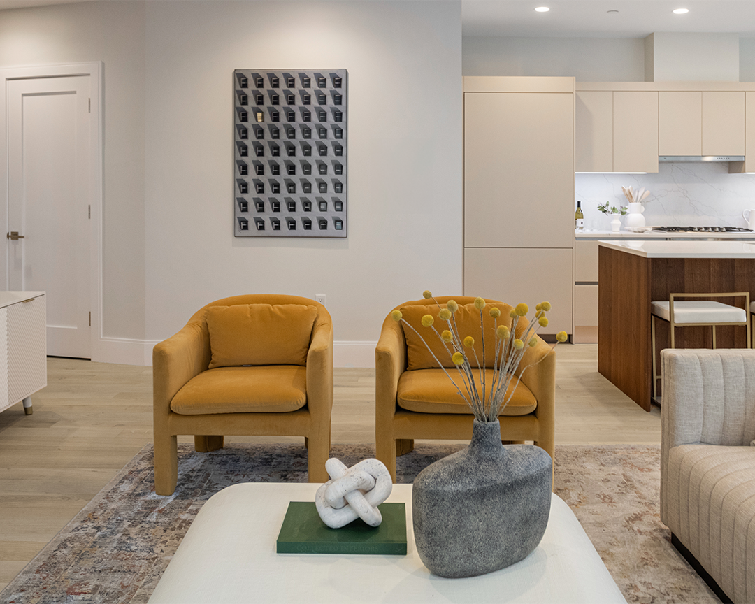 neutral living space with mid century modern chairs and wide plank wood floors
