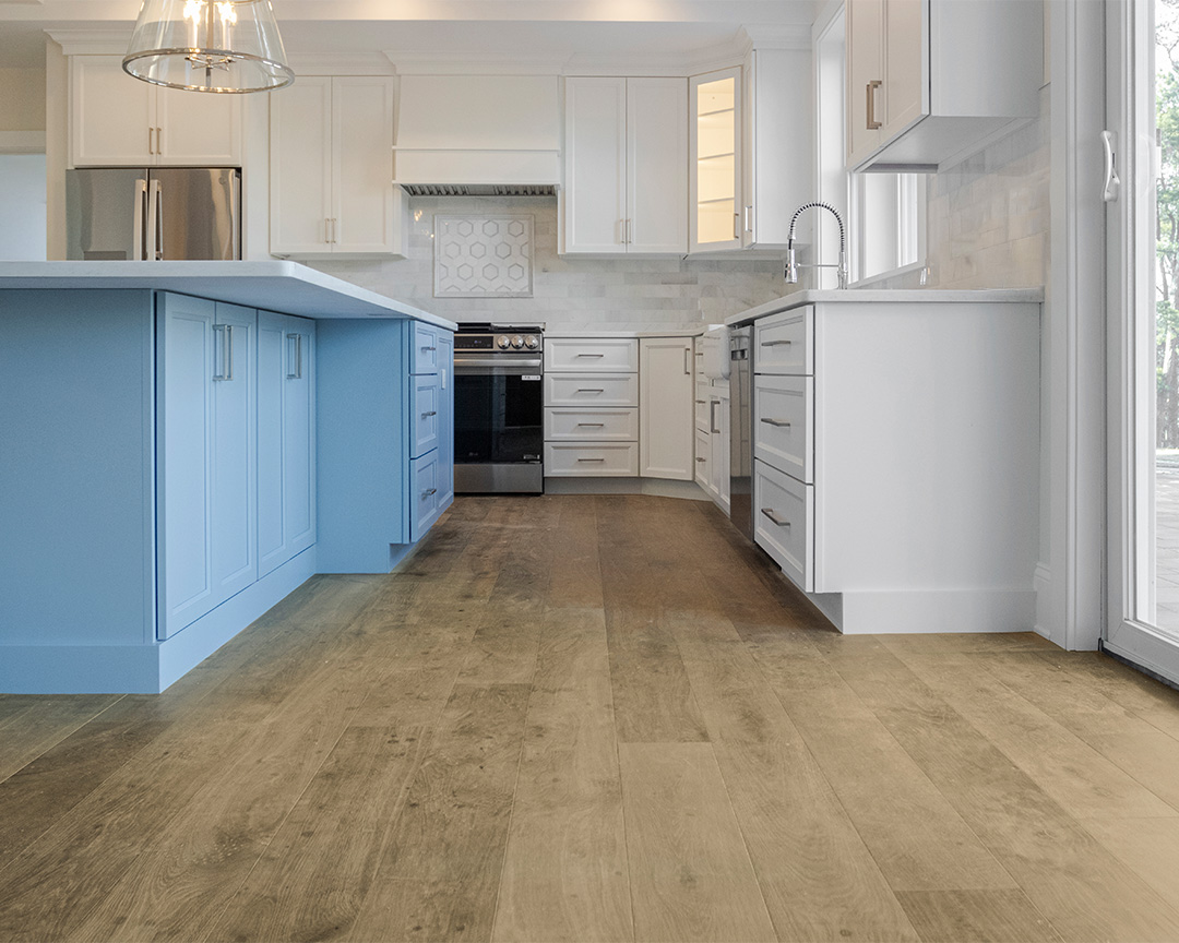 Modern kitchen with warm brown wide plank flooring