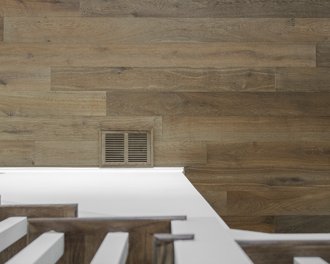 natural brown engineered wide plank flooring with matching air grille